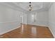 Formal dining room with hardwood floors, modern chandelier, tray ceiling, and natural light at 5317 Chimney Swift Dr, Wake Forest, NC 27587