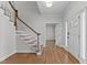 Inviting foyer with hardwood floors, staircase, and a view into the living spaces at 5317 Chimney Swift Dr, Wake Forest, NC 27587