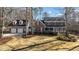 Traditional brick home with blue shutters, white trim, a lush green lawn, and an attached two car garage at 5317 Chimney Swift Dr, Wake Forest, NC 27587