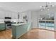 Bright kitchen with white subway tile, marbled countertops, green cabinetry, and stainless steel appliances at 5317 Chimney Swift Dr, Wake Forest, NC 27587