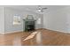 Bright living room featuring hardwood floors, two windows, and a marble fireplace at 5317 Chimney Swift Dr, Wake Forest, NC 27587