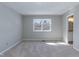 Comfortable bedroom with a window view and an ensuite bathroom entrance at 535 Darby Glen Ln, Durham, NC 27713