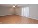 Bright living room with wood floors, a ceiling fan, and white curtain at 535 Darby Glen Ln, Durham, NC 27713