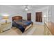 Cozy bedroom featuring a decorative blue comforter and natural light from two windows with patterned curtains at 54 W Myrtle Dr # A, Angier, NC 27501