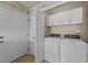 Functional laundry room with modern washer and dryer, adjacent to a storage area at 54 W Myrtle Dr # A, Angier, NC 27501