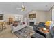 Cozy living room featuring a fireplace, ceiling fan, and open layout with a dining area at 54 W Myrtle Dr # A, Angier, NC 27501