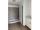 Bathroom showcasing a tiled shower, vanity with countertop, and a modern design at 58 Shay St, Angier, NC 27501