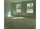 Bright, unfinished bedroom with natural light from two windows; a blank canvas awaiting personalization at 58 Shay St, Angier, NC 27501