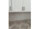 Close-up of kitchen backsplash and cabinets, featuring a unique tile design and modern hardware at 58 Shay St, Angier, NC 27501
