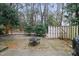 View of backyard area with mature trees and fire pit at 5840 Branchwood Rd, Raleigh, NC 27609