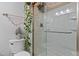 Bathroom shower with glass door, decorative lights and toilet at 5840 Branchwood Rd, Raleigh, NC 27609