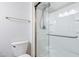 Clean bathroom featuring a glass door shower, a toilet, and a chrome towel bar at 5840 Branchwood Rd, Raleigh, NC 27609