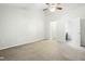 Bedroom featuring a ceiling fan, neutral-colored walls, and a door leading to the bathroom at 5840 Branchwood Rd, Raleigh, NC 27609