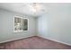 Bright bedroom featuring a ceiling fan, neutral-colored walls, carpet flooring, and a window at 5840 Branchwood Rd, Raleigh, NC 27609
