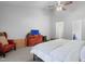 Spacious primary bedroom with cozy red chair, dresser and ceiling fan at 5840 Branchwood Rd, Raleigh, NC 27609