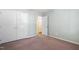Bedroom features carpet flooring, neutral-colored walls, and a closet in a well-lit space at 5840 Branchwood Rd, Raleigh, NC 27609