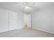 This bedroom features neutral carpet and walls, ceiling fan, and closet at 5840 Branchwood Rd, Raleigh, NC 27609
