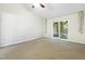Spacious bedroom featuring a ceiling fan, a glass sliding door, and neutral-colored walls at 5840 Branchwood Rd, Raleigh, NC 27609