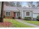 Charming townhouse with a brick facade, well-maintained lawn, and inviting walkway to the front door at 5840 Branchwood Rd, Raleigh, NC 27609
