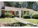 Charming single-story home with a brick facade, landscaped yard, and inviting walkway at 5840 Branchwood Rd, Raleigh, NC 27609