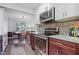 Modern kitchen featuring stainless steel appliances, granite countertops, and wood cabinets at 5840 Branchwood Rd, Raleigh, NC 27609