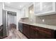 Bright kitchen with modern appliances, wood floors, granite countertops, and white and wood cabinets at 5840 Branchwood Rd, Raleigh, NC 27609