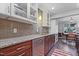 Modern kitchen featuring granite counters, stainless steel appliances, and glass-front cabinets at 5840 Branchwood Rd, Raleigh, NC 27609