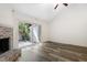 Cozy living room featuring a brick fireplace, wood floors, and a sliding door to the backyard at 5840 Branchwood Rd, Raleigh, NC 27609