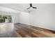 Spacious living room featuring wood floors, a ceiling fan, and sliding door to the outdoor space at 5840 Branchwood Rd, Raleigh, NC 27609