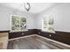 Light-filled room with wood floors, two windows, and stylish wall design with neutral color palette at 5840 Branchwood Rd, Raleigh, NC 27609