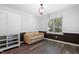 Neutral living space features wood floors, a tan sofa, and plenty of natural light at 5840 Branchwood Rd, Raleigh, NC 27609