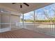 Spacious screened porch with a ceiling fan and wood flooring, perfect for outdoor relaxation at 61 Merlot Court Ct, Clayton, NC 27520