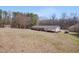 Aerial view of home showcasing a spacious lot, mature trees, and outbuildings at 6605 Pearces Rd, Louisburg, NC 27549