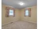 Bedroom featuring neutral walls, carpet, two windows with curtains at 6605 Pearces Rd, Louisburg, NC 27549