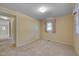 Cozy bedroom featuring neutral carpet, light walls, and a window with floral patterned curtains at 6605 Pearces Rd, Louisburg, NC 27549