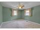 Bedroom featuring light green walls, carpet, two windows and ceiling fan with light at 6605 Pearces Rd, Louisburg, NC 27549