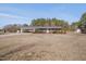 One-story brick home features a covered carport and is situated on a spacious lawn at 6605 Pearces Rd, Louisburg, NC 27549