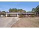Charming one-story brick home with an attached carport and well-maintained front yard landscaping at 6605 Pearces Rd, Louisburg, NC 27549