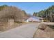 Charming single-story home with a long driveway and mature trees in the front yard at 6605 Pearces Rd, Louisburg, NC 27549