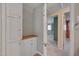 Hallway with wood floors, built in cabinets, and access to multiple rooms at 6605 Pearces Rd, Louisburg, NC 27549