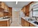 This kitchen features wooden cabinets, white countertops, and seamless access to other rooms at 6605 Pearces Rd, Louisburg, NC 27549