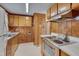 Cozy kitchen features wooden cabinets, white countertops and appliances at 6605 Pearces Rd, Louisburg, NC 27549