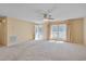 Bright and airy living room showcasing plush carpeting and abundant natural light from large windows at 6605 Pearces Rd, Louisburg, NC 27549