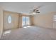 Comfortable living room featuring neutral carpet, large windows, and ample space for furnishings at 6605 Pearces Rd, Louisburg, NC 27549