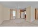 Bright living room space with large windows, cozy carpet, and an open layout into the dining area at 6605 Pearces Rd, Louisburg, NC 27549