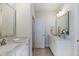 Bright bathroom featuring double vanity, marble countertops and modern fixtures at 8013 Ghost Pony Trl, Raleigh, NC 27613