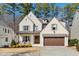 Charming two-story home featuring a brick exterior, covered porch, and a well-manicured front yard at 8013 Ghost Pony Trl, Raleigh, NC 27613