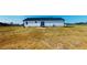Back exterior view of a vinyl sided home featuring a sliding glass door and concrete patio at 82 Asher Pointe Way, Benson, NC 27504