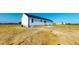 Back exterior view of a vinyl sided home featuring a basement and concrete patio at 82 Asher Pointe Way, Benson, NC 27504