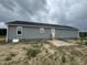 This exterior view shows the back of the home with a door and dark roof at 82 Asher Pointe Way, Benson, NC 27504